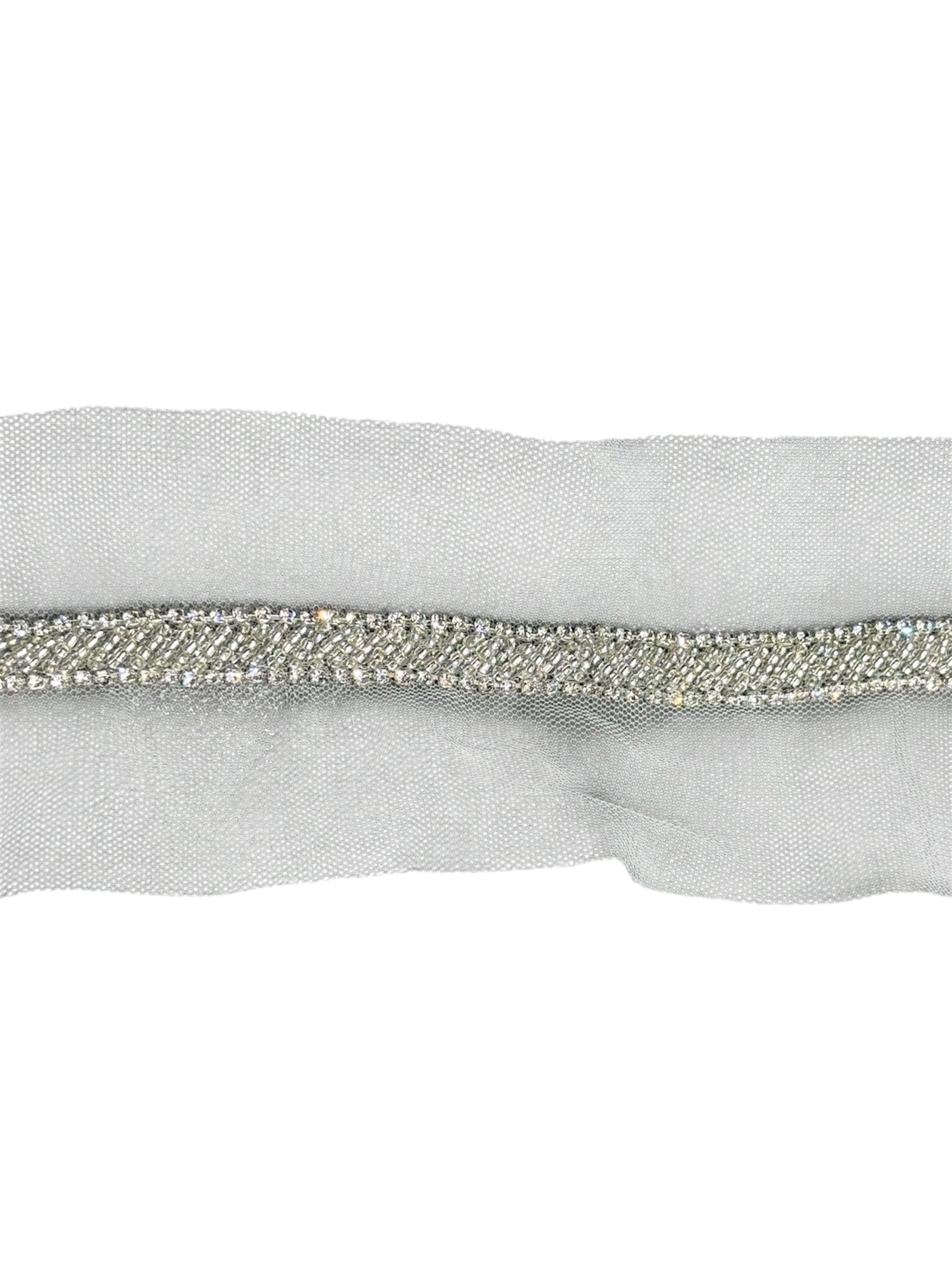 Silver embroidered fabric trim with a mesh backing.