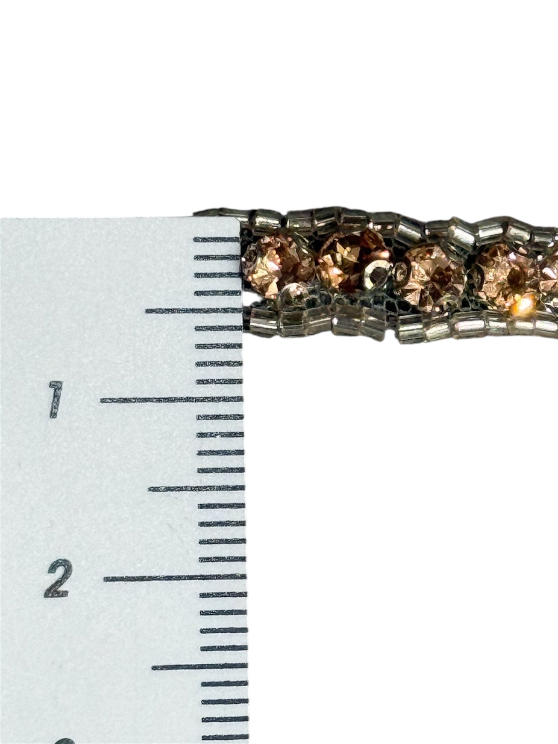 Beige netted trim with clear beads, measured against a ruler.