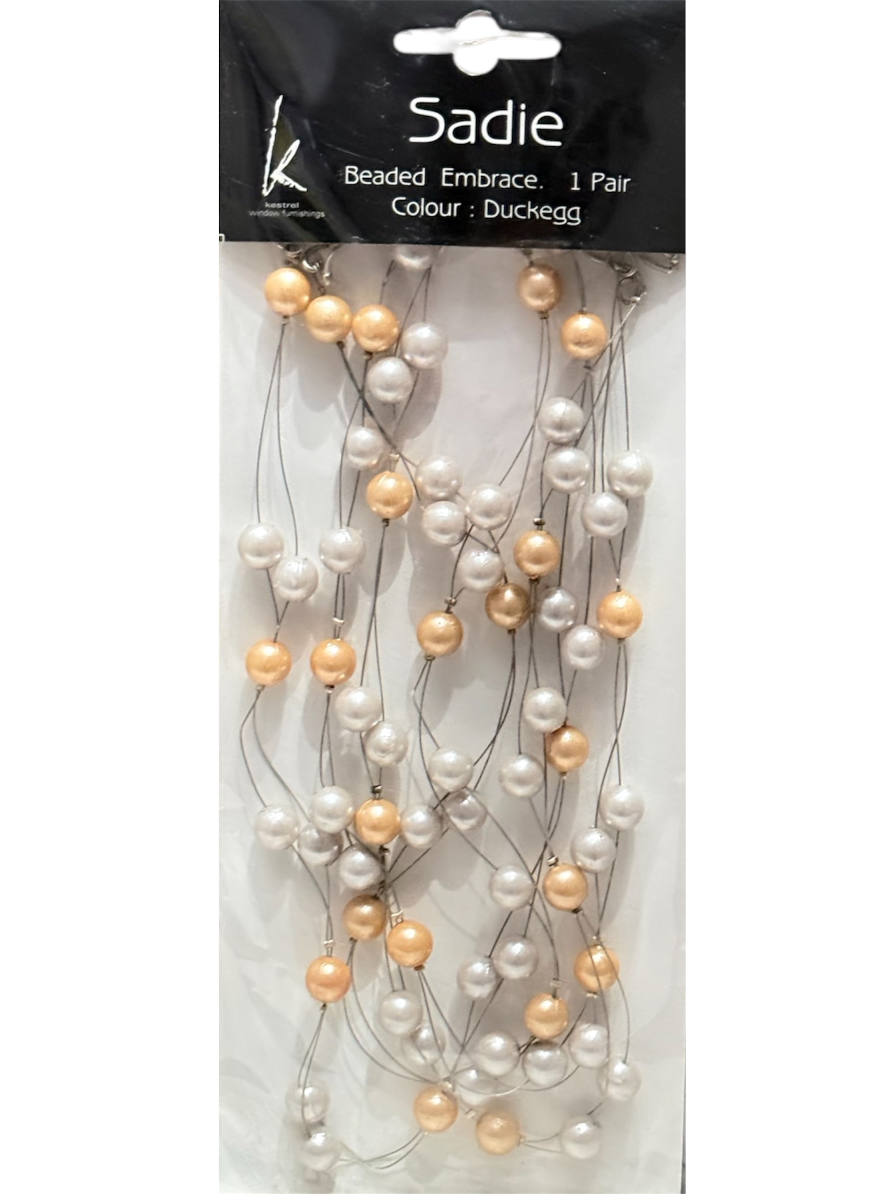 A pair of Sadie beaded and wired faux pearl curtain tie backs in duckegg with ivory and gold beads.