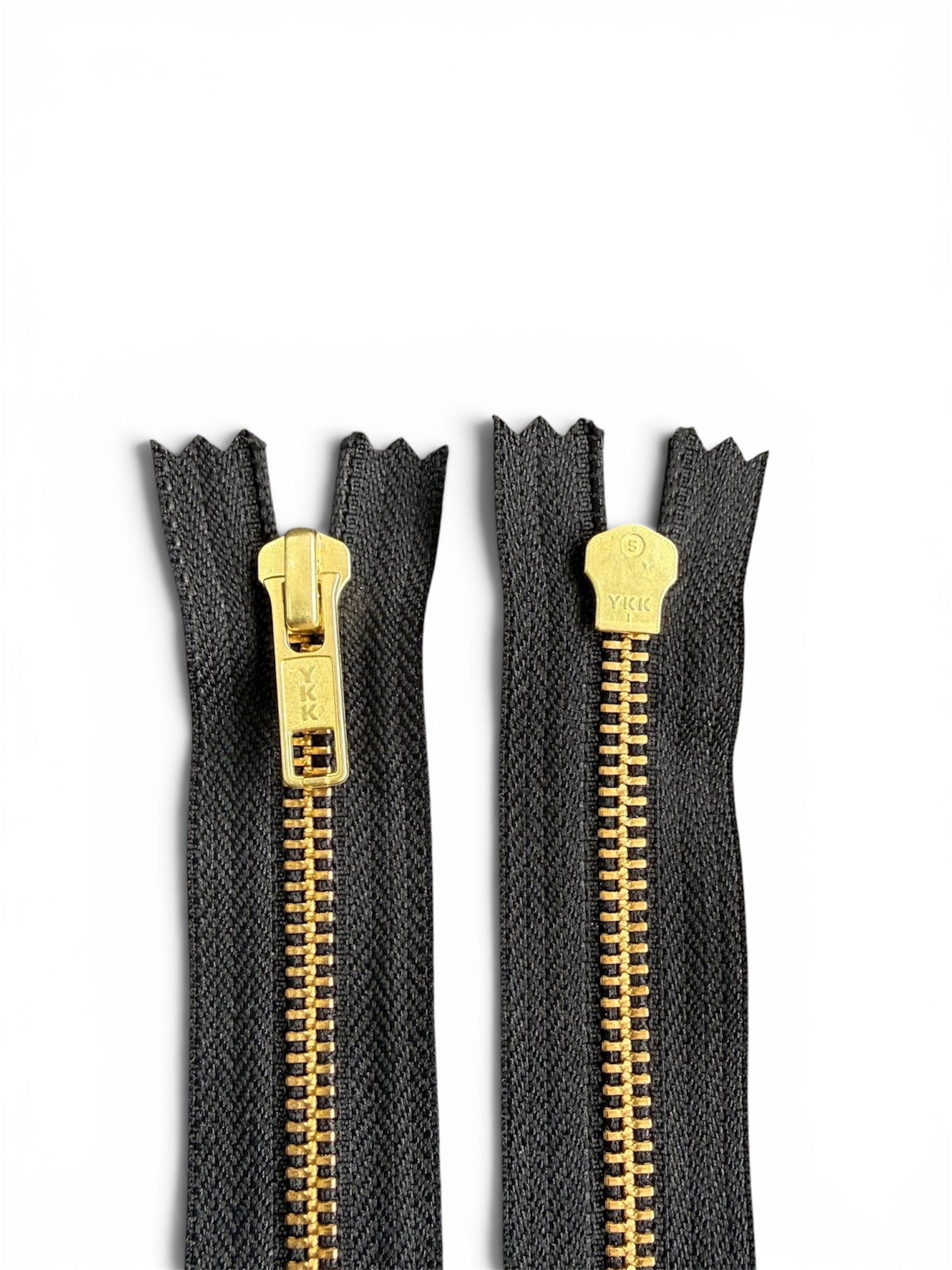 Two YKK size 5 black zippers with golden metal teeth and sliders, front and back views.