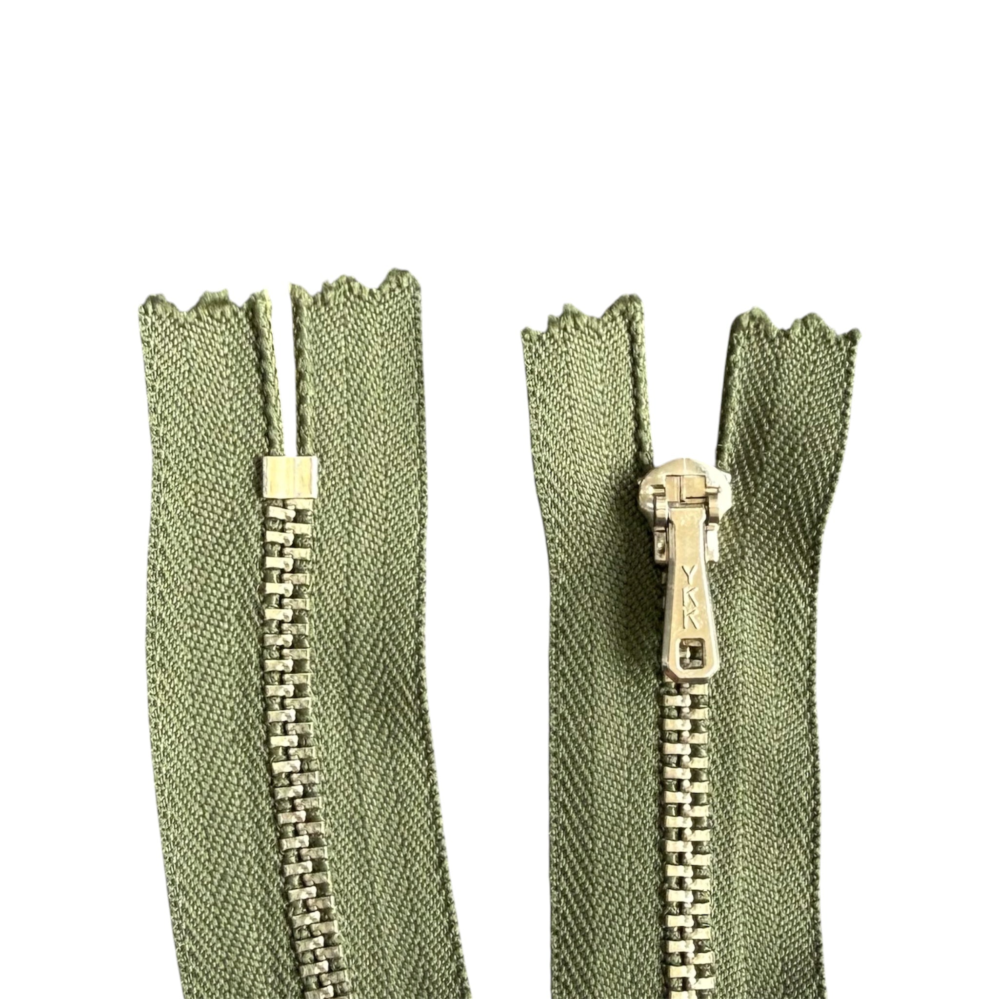 YKK 18cm closed end metal zipper with silver teeth and green tape shown from front and back.