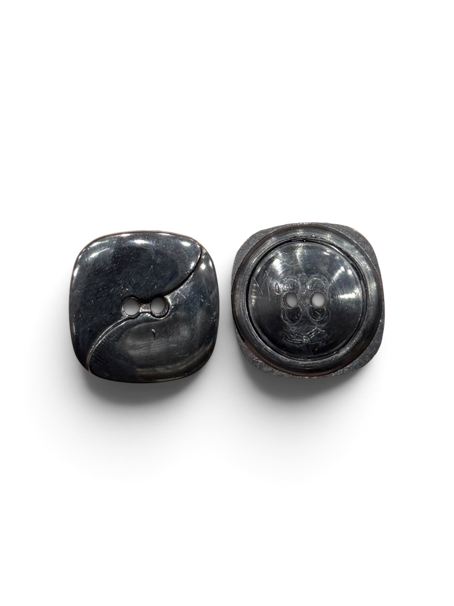 Two dark navy and black resin 2-hole sewing buttons in 11mm and 22mm sizes.