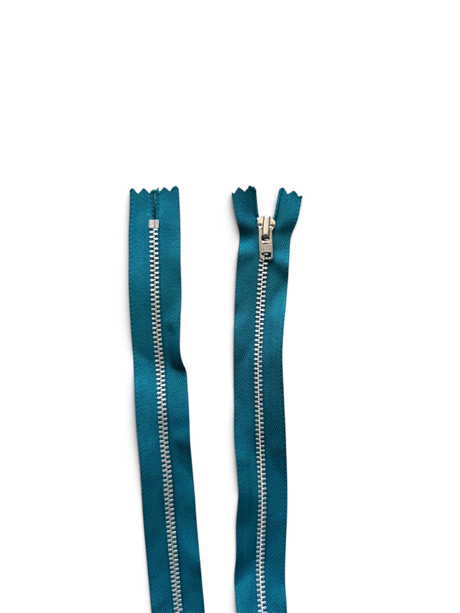 YKK 55cm teal closed end metal zipper with silver finish teeth on a white background.