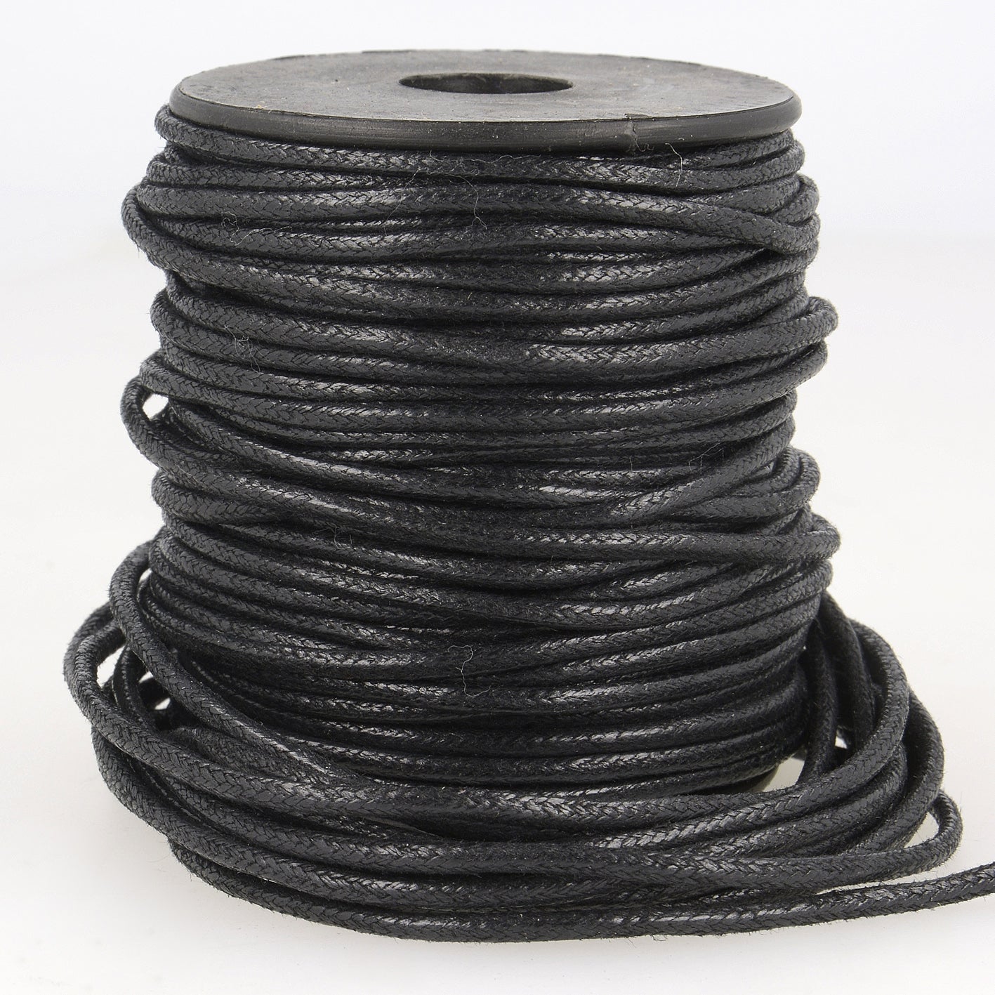 Spool of 2mm black faux leather cord with a braided texture for jewelry and garment projects.
