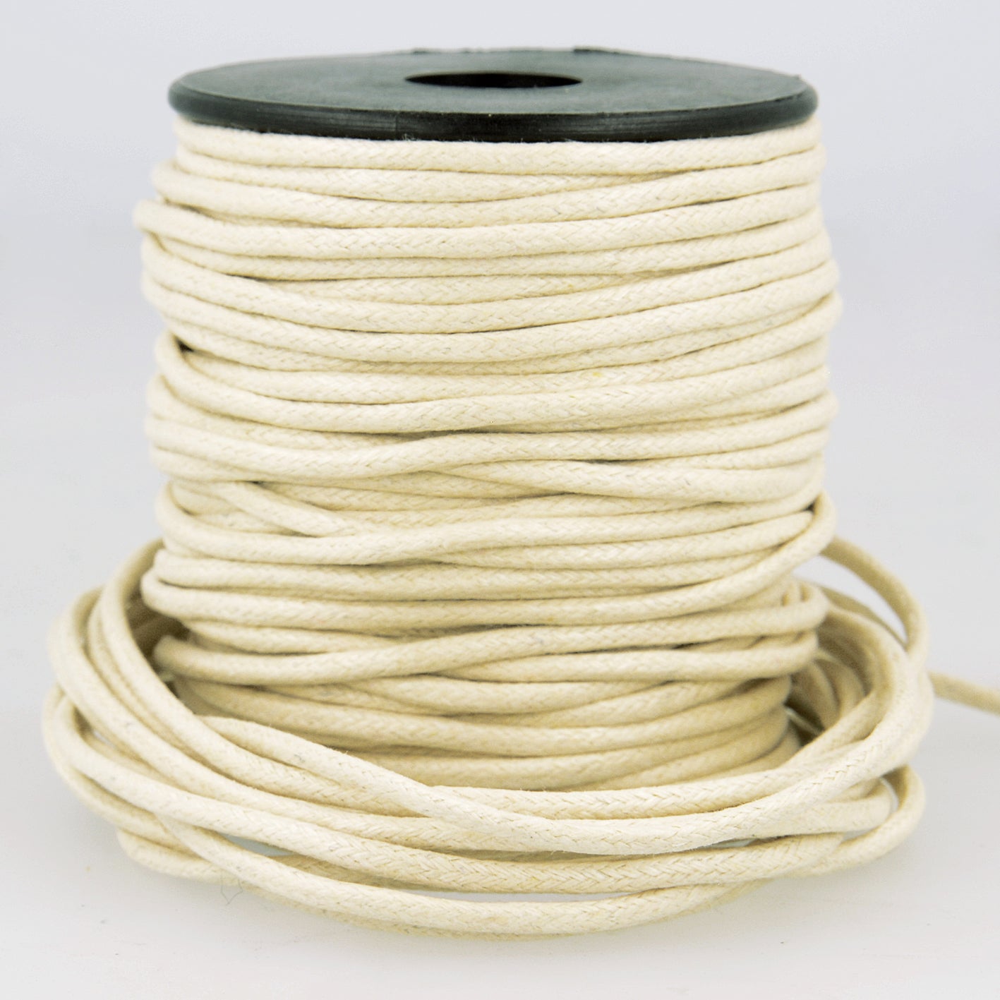 Spool of 2mm cream-colored faux leather cord with a braided texture.