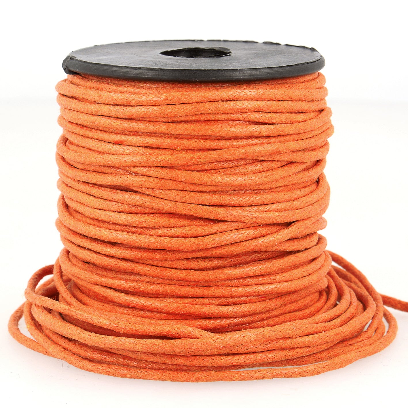Spool of 2mm orange faux leather cord with a cotton-based core for jewelry and garment projects.