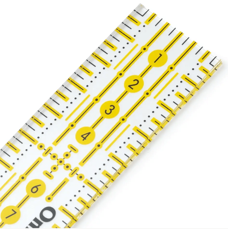 Transparent yellow plastic ruler with black metric markings and numbered circles.