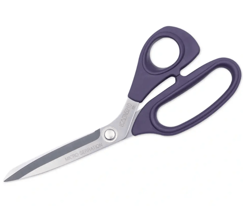 Purple dressmaking shears with micro-serration and stainless steel blades.