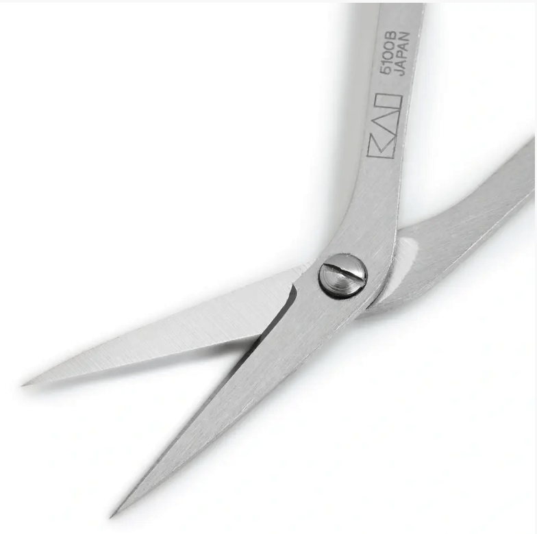 Curved 10cm stainless steel embroidery scissors with KAI branding.