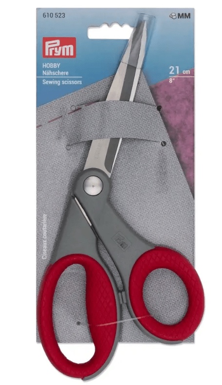 Red and grey sewing scissors with red handles.