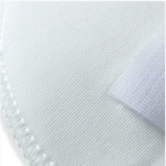 White oval polyester shoulder pads with hook and loop fastening.
