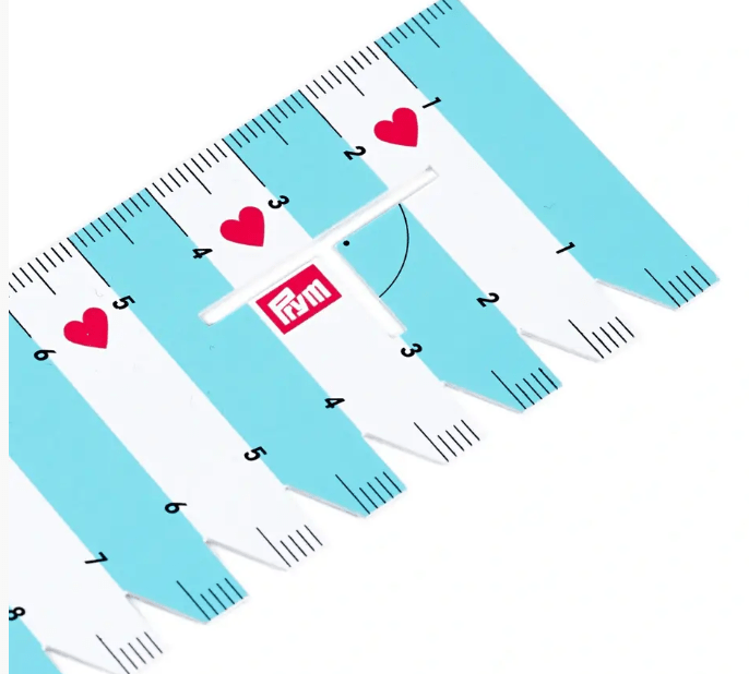 Prym Love flexible plastic hand gauge with mint and white stripes and red hearts.