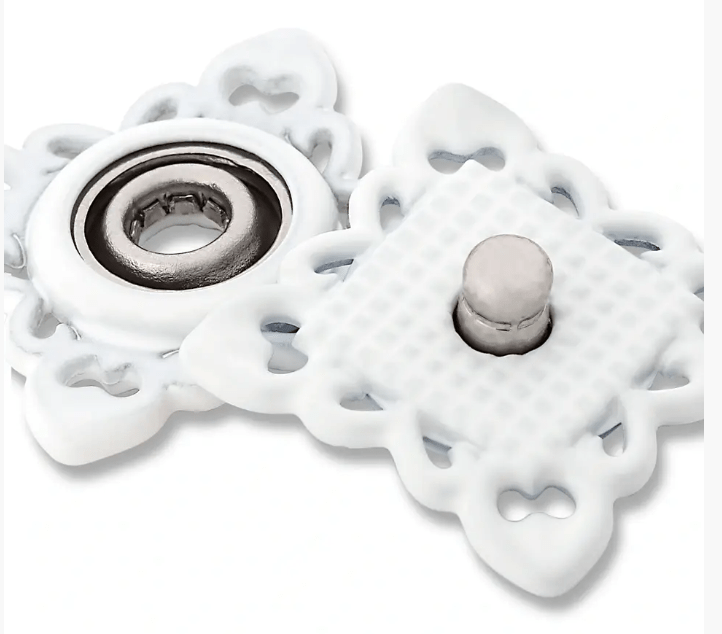 White square sew-on snap fasteners with decorative edges and metal centers.