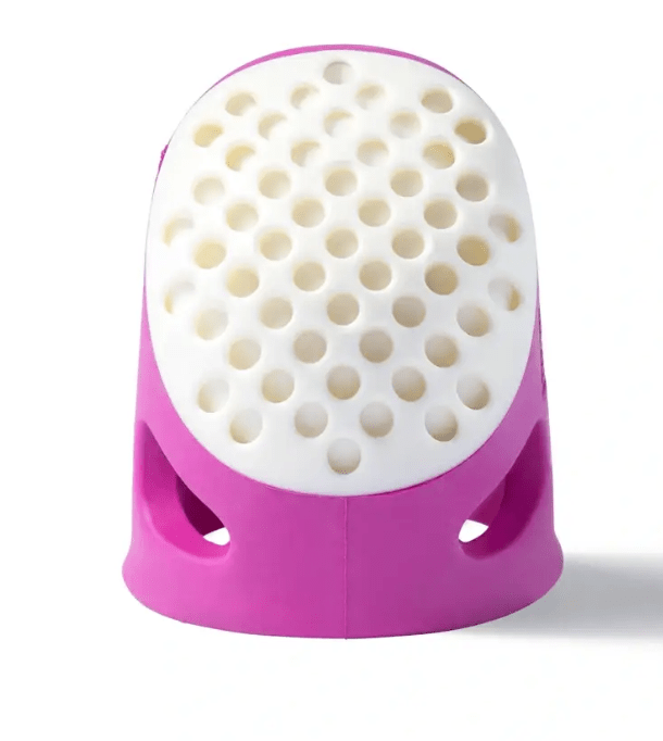 Prym.ergonomics soft comfort thimble with white dotted top and pink vented base.