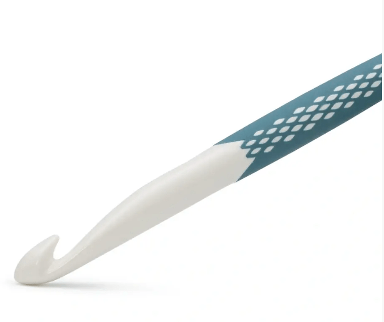 Ergonomic crochet hook with a petrol green handle and white tip.