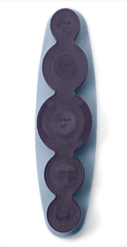 Plastic tool for making covered metal buttons in multiple sizes.