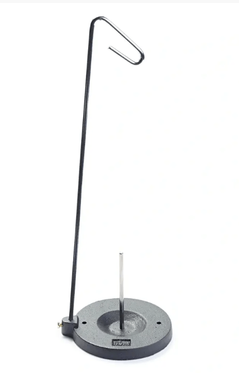 Silver metal cone and spool stand with a black cast iron base.