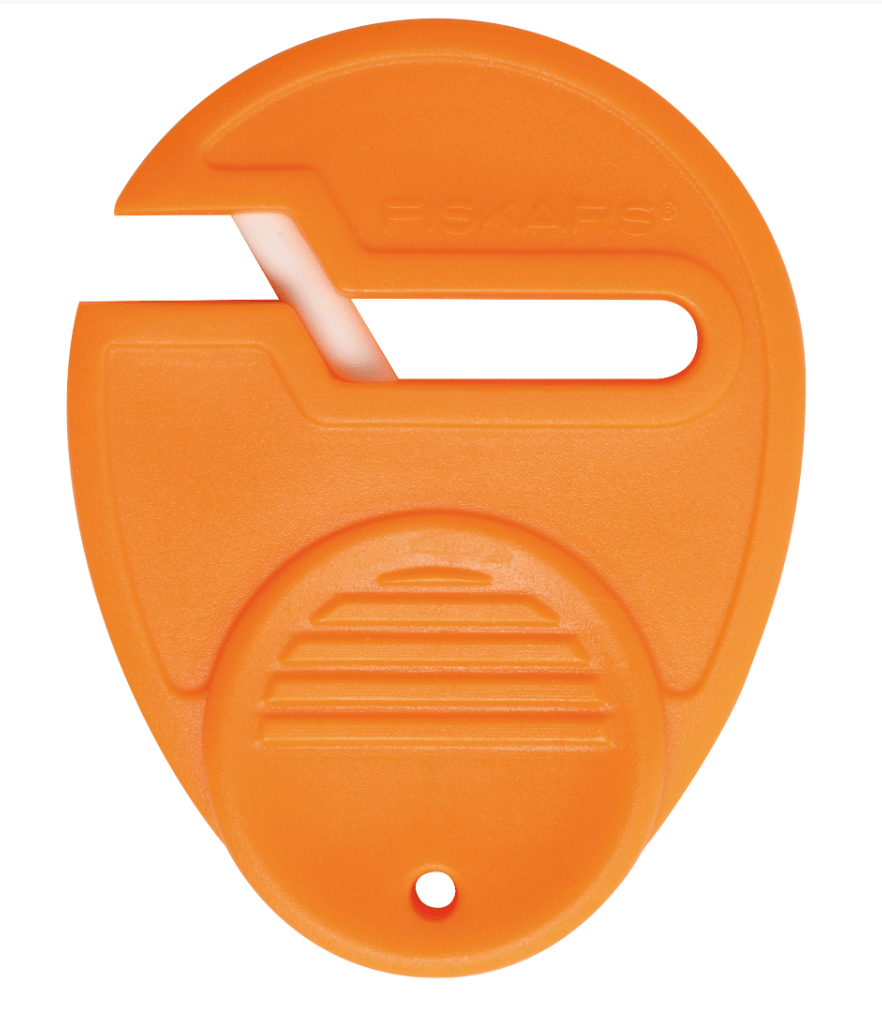 Fiskars orange compact scissor sharpener with a white blade.