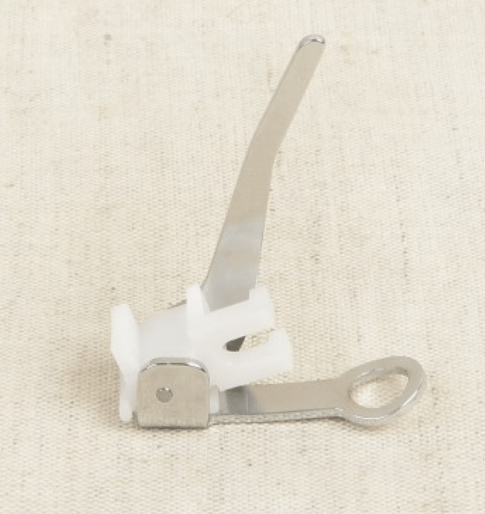 Sewing machine darning foot with a zinc accessory.