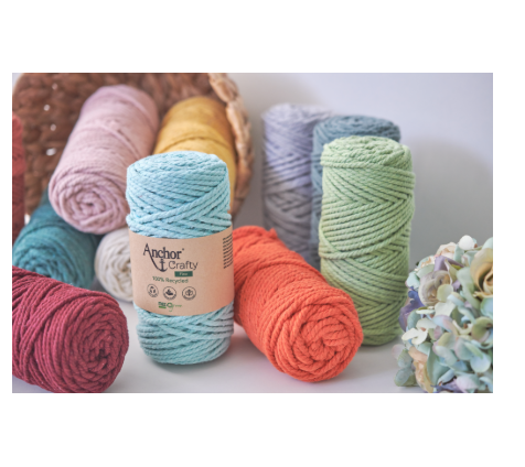 Spools of eco-friendly 3mm twisted crochet yarn in various natural colors.