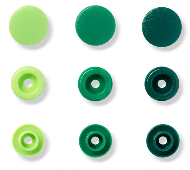 Assorted green plastic snap fasteners in three sizes.