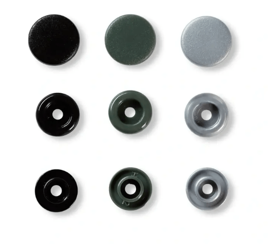 Nine assorted color snap fasteners in three rows of three.
