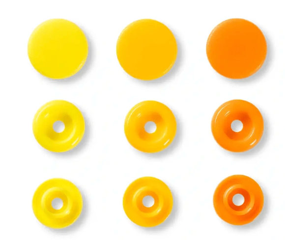 Assorted color plastic snap fasteners in a grid pattern.