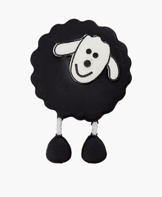 Black sheep-shaped button with white face and black feet.