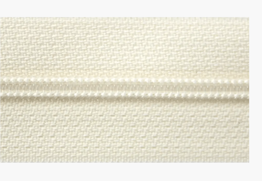 Cream colored 3mm polyester zipper with a textured fabric tape.