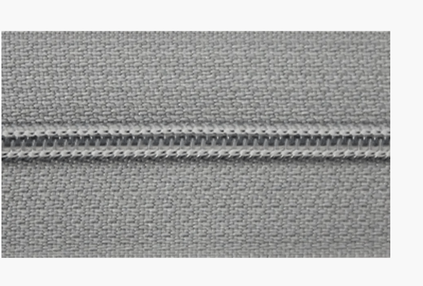 Endless zipper with 3mm polyester monofilament teeth on grey fabric.