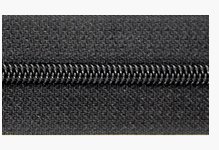 Endless zipper with 3mm polyester monofilament teeth on a dark fabric.