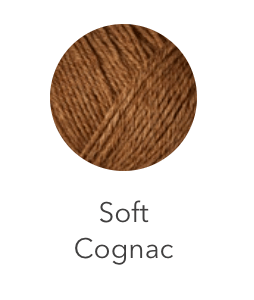 A ball of soft cognac colored heavy merino wool yarn.
