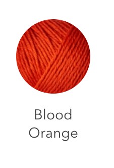 A ball of blood orange colored heavy merino wool yarn.