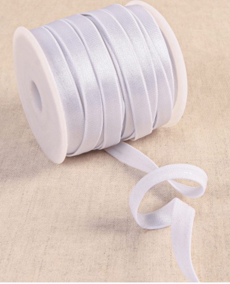 White coated elastic tape on a spool.