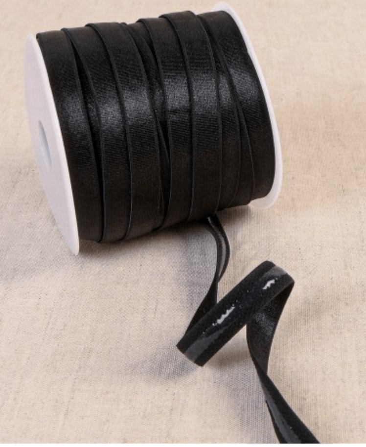 Black coated elastic tape on a spool, made of polyester, silicon, and spandex.