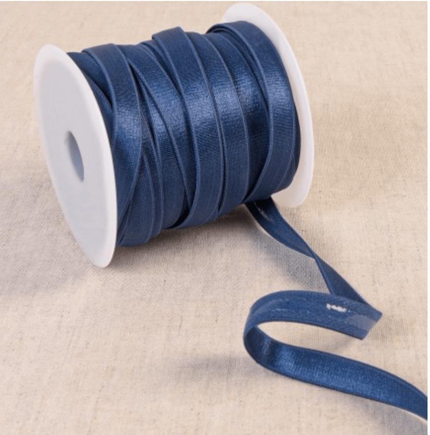 Dark blue coated elastic tape on a white spool.