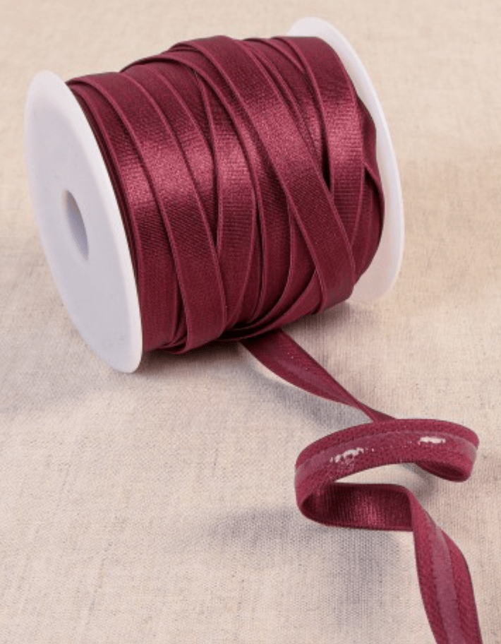 Maroon coated elastic tape with a polyester, silicon, and spandex blend.