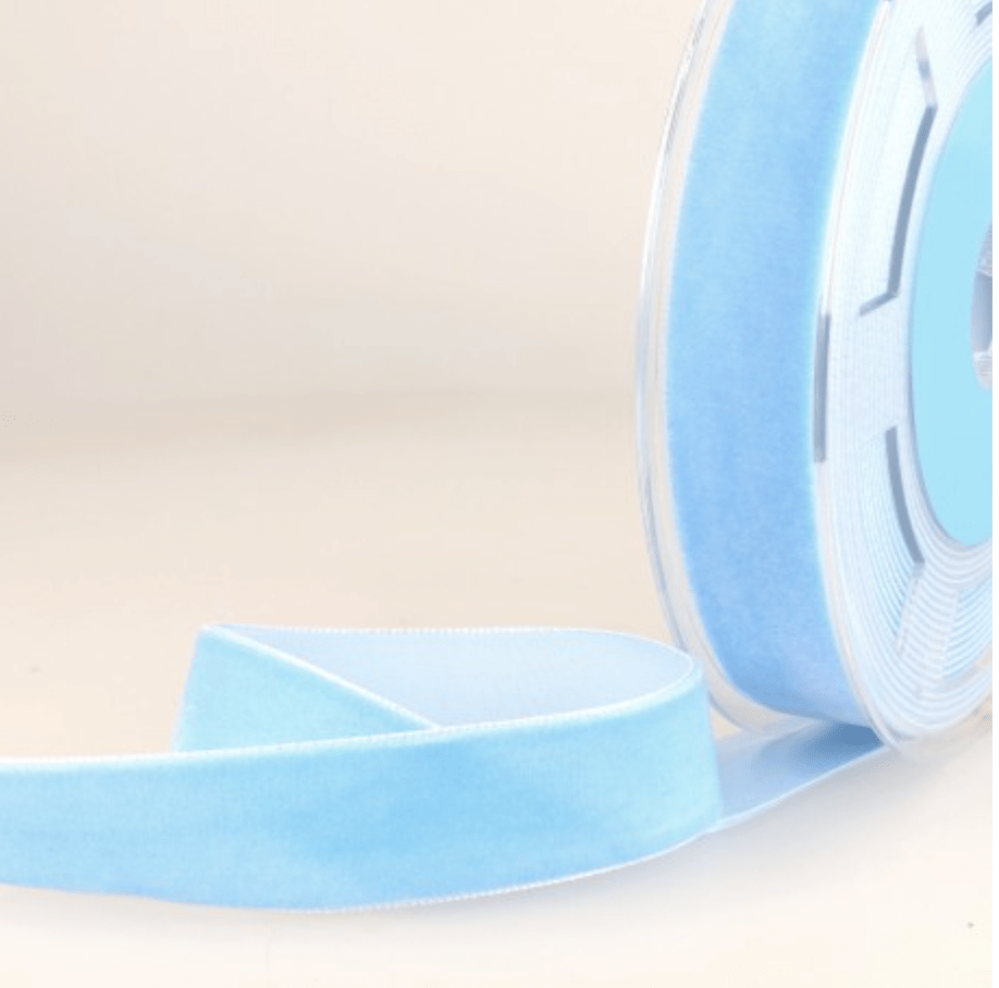Blue velvet ribbon on a spool.