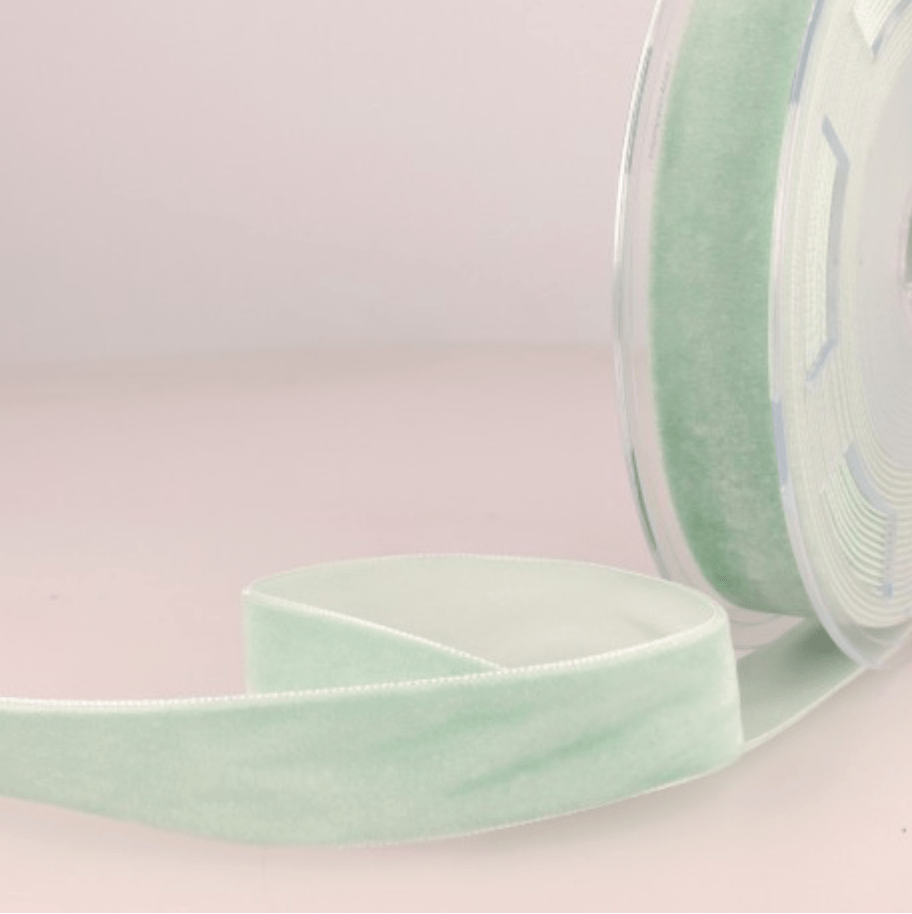 Light green velvet ribbon on a spool.