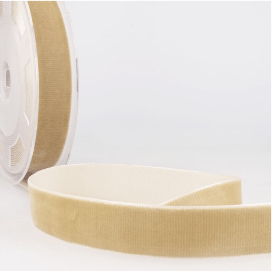 A roll of beige velvet ribbon with a high-density texture.