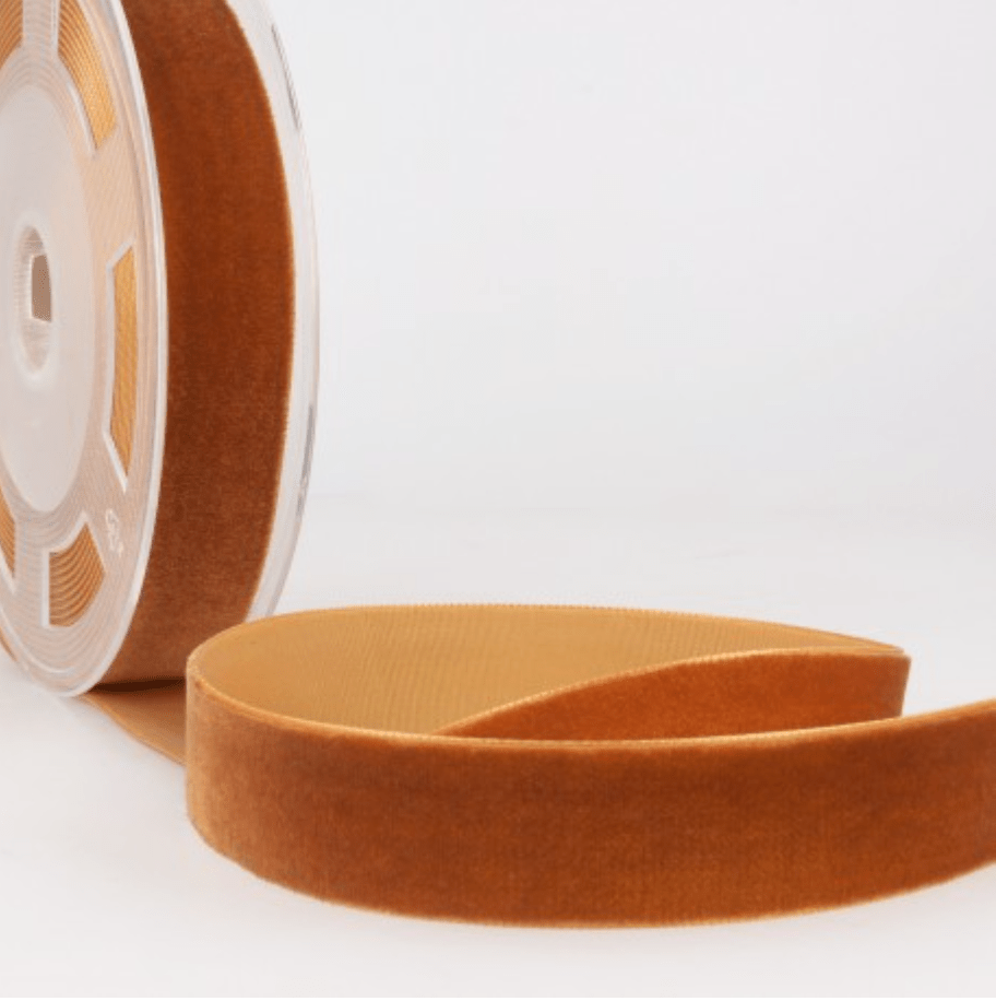 A roll of 7mm wide, copper-colored velvet ribbon.