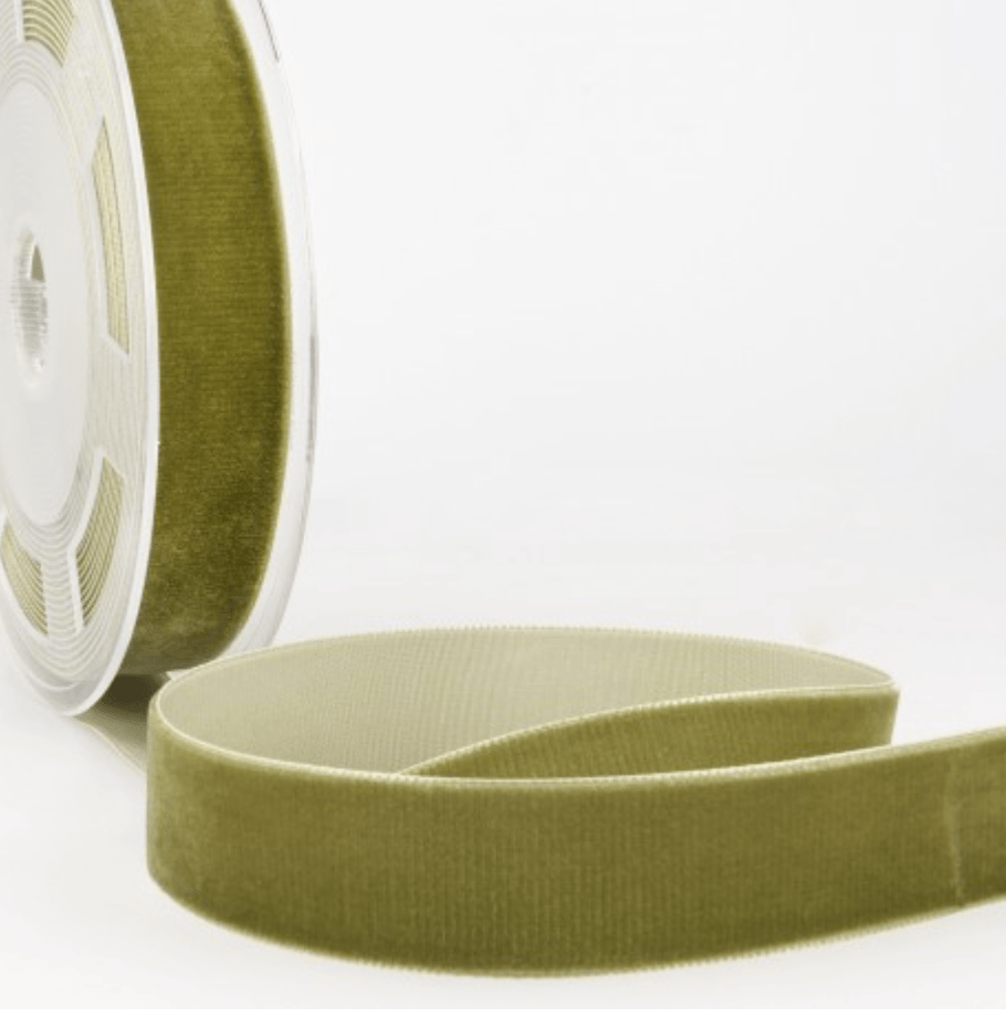 A roll of olive green velvet ribbon with a ribbed texture.