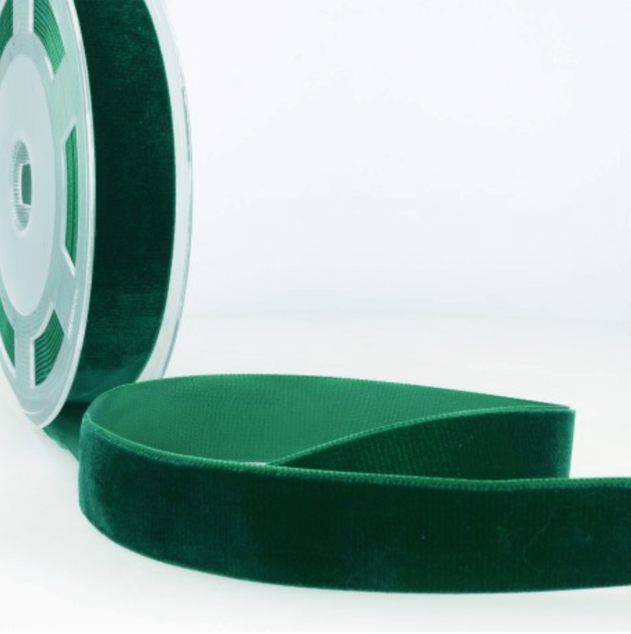Dark green velvet ribbon on a spool.