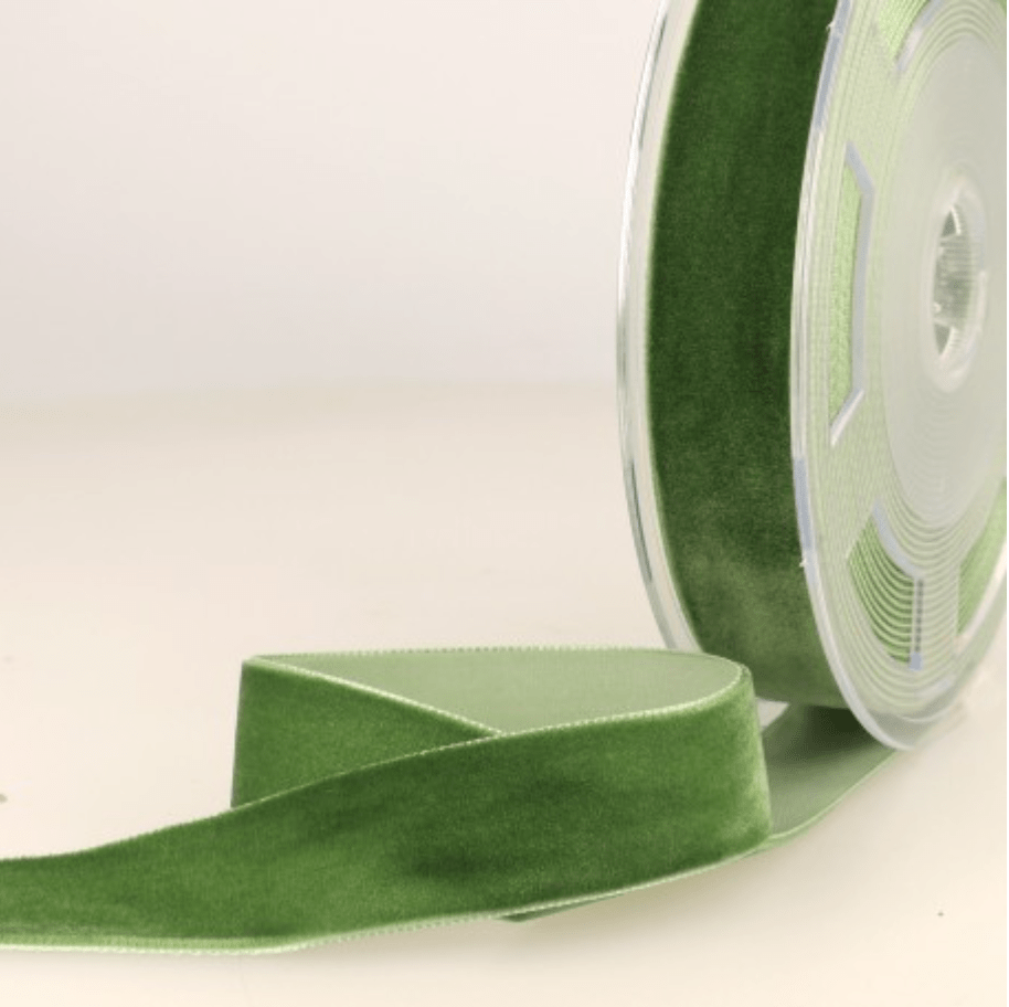 Green velvet ribbon on a spool.
