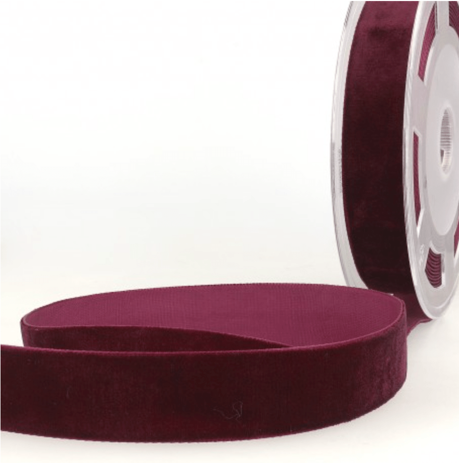 Burgundy velvet ribbon on a spool.