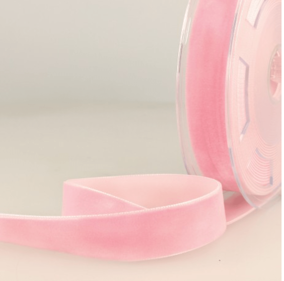 Pink velvet ribbon on a spool.