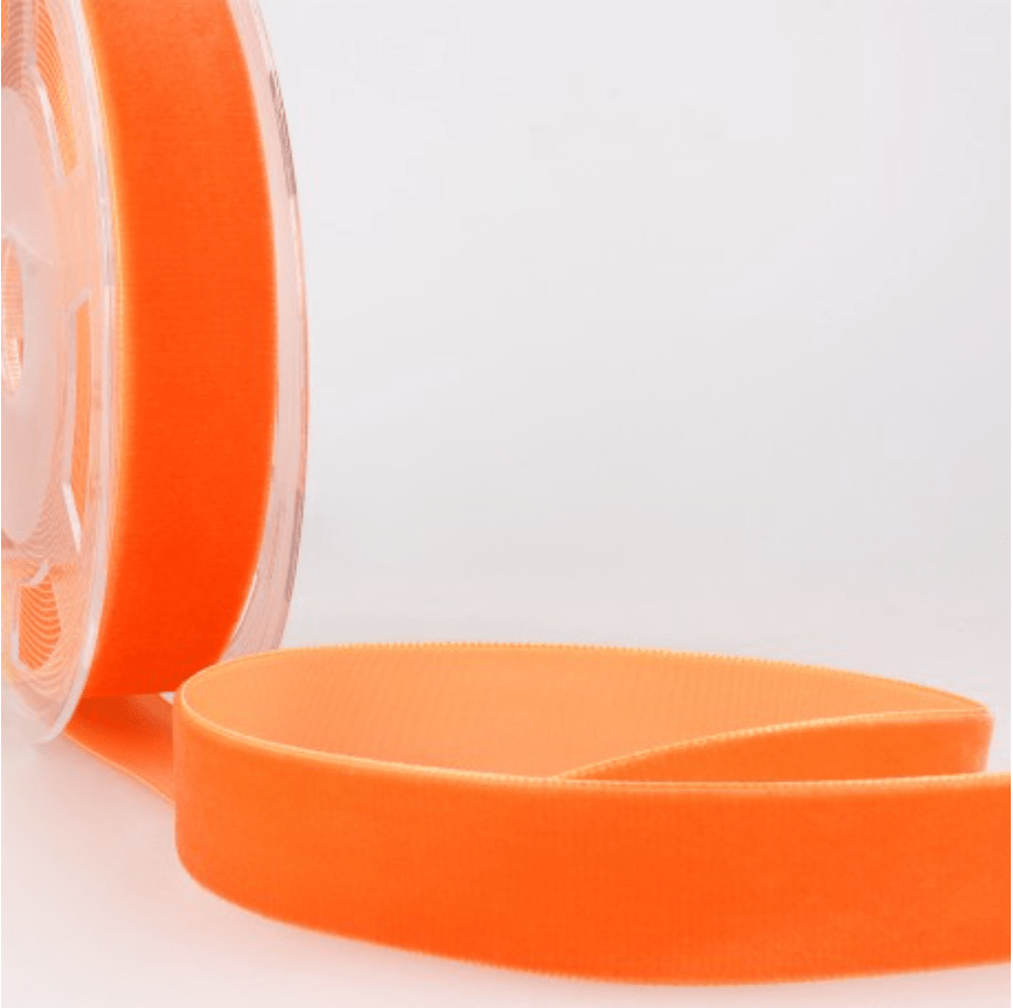 Orange velvet ribbon on a spool.