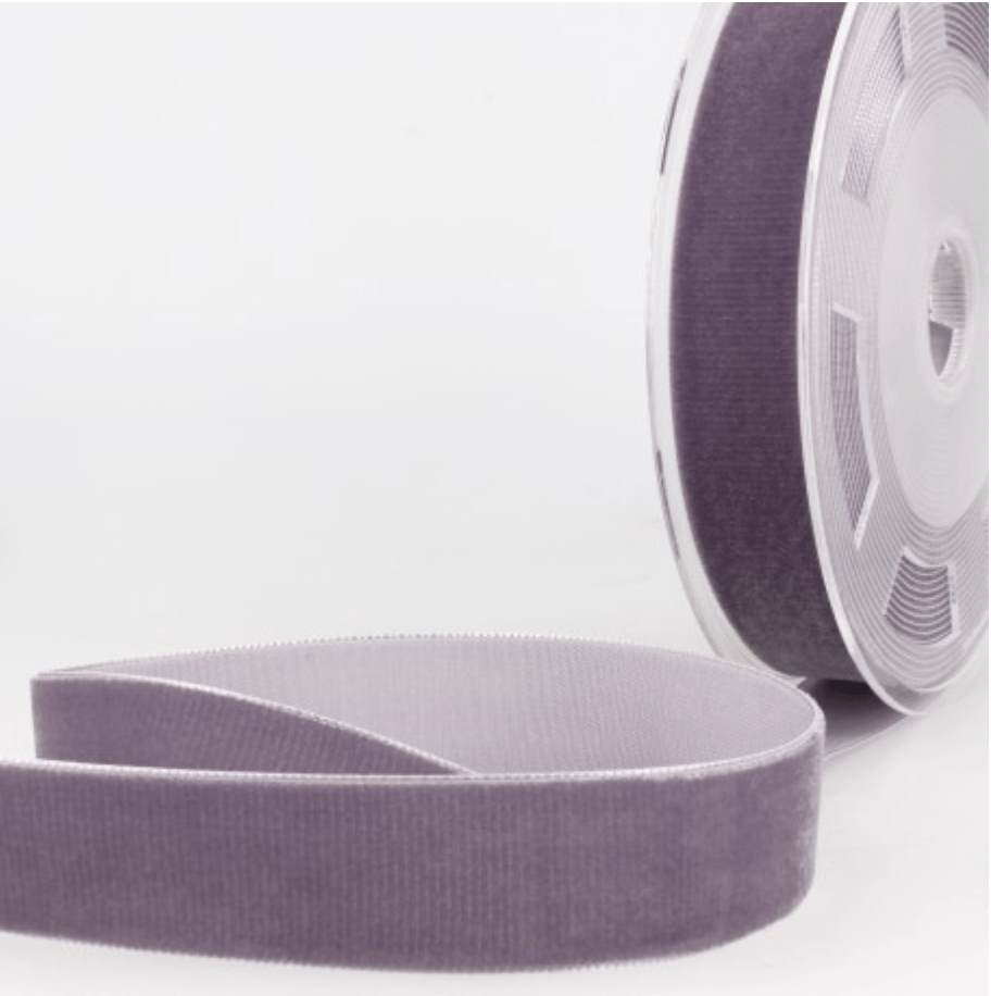 A roll of purple velvet ribbon with a textured surface.