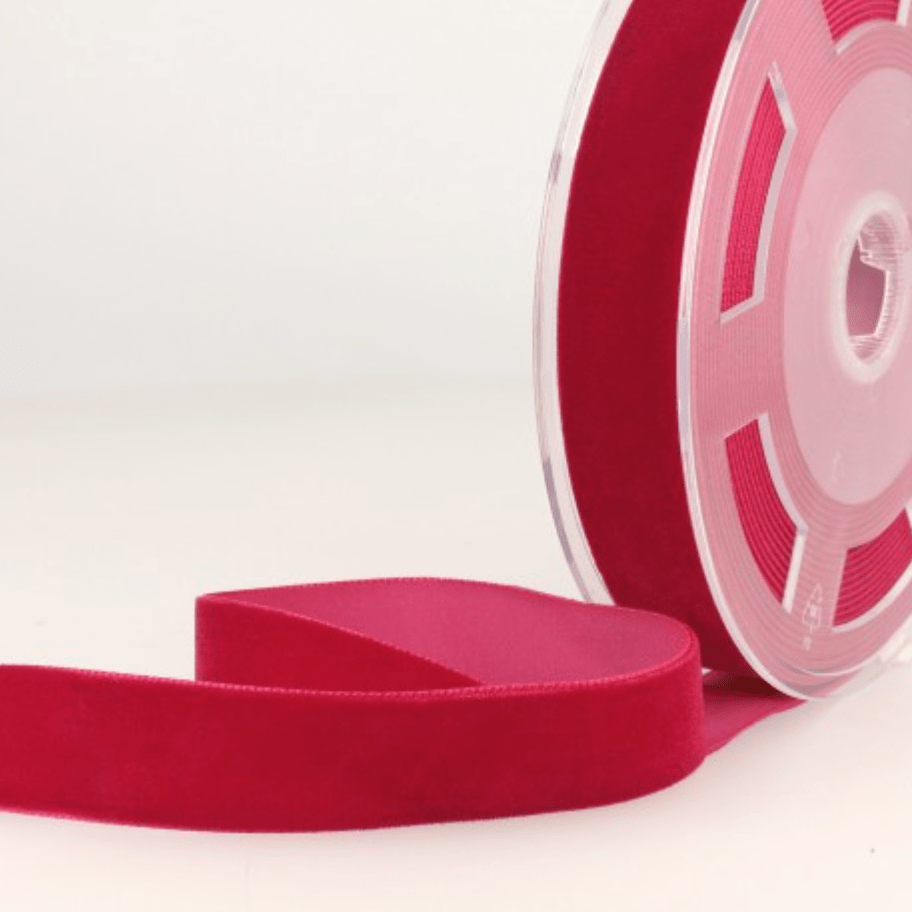 Rouge velvet ribbon on a spool.