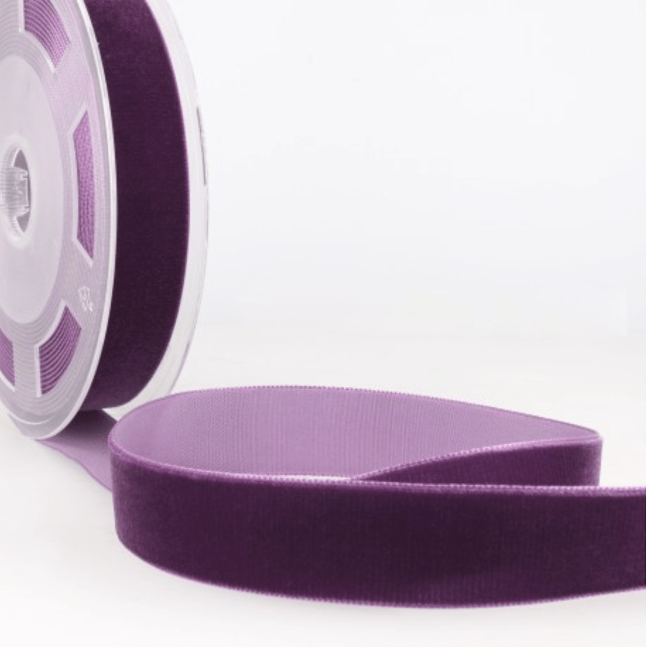 Purple velvet ribbon on a spool.